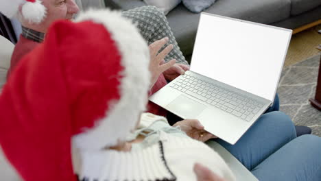 Happy-senior-caucasian-couple-having-christmas-laptop-video-call-with-copy-space,-slow-motion