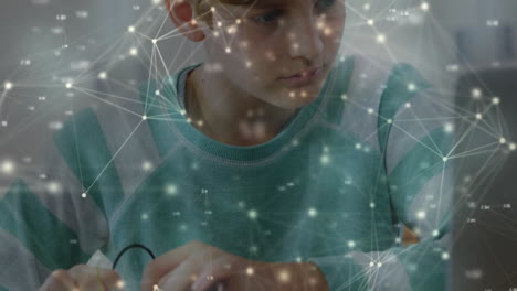 Animation-of-network-of-connected-circles-over-focused-caucasian-boy-using-laptop