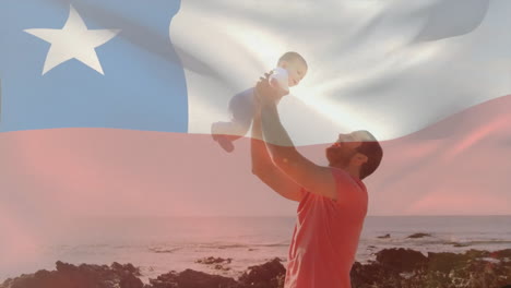 Animation-of-chilean-flag-over-caucasian-father-holding-up-baby-on-beach