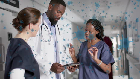 Animation-of-floating-viruses-over-diverse-doctors-talking-in-hospital-corridor