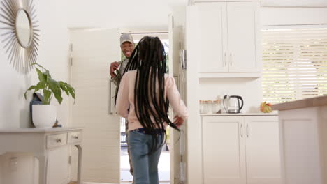 Happy-african-american-male-soldier-embracing-his-daughter-at-home,-slow-motion