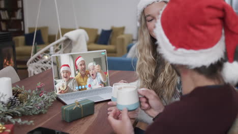Happy-caucasian-couple,-father-and-sons-having-christmas-laptop-video-call,-slow-motion
