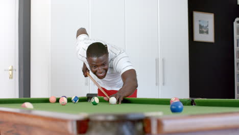 Young-African-American-man-playing-pool-at-home