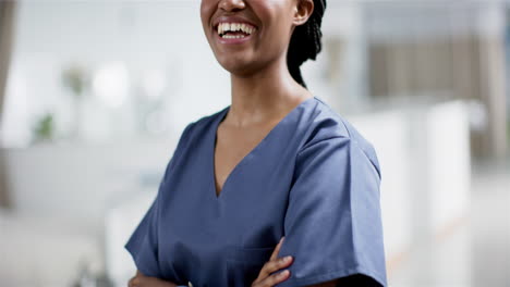 Portrait-of-happy-african-american-female-doctor-wearing-scrubs-in-hospital,-slow-motion