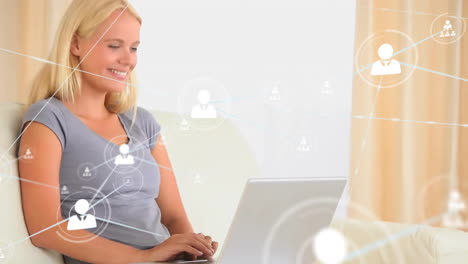 Animation-of-network-of-connected-icons-in-circles-over-happy-caucasian-woman-using-laptop