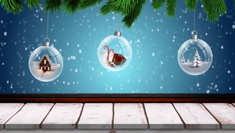 Animation-of-snow-falling-over-christmas-decorations-baubles-and-winter-scenery