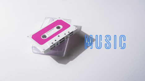 Animation-of-music-text-over-tape-on-white-background