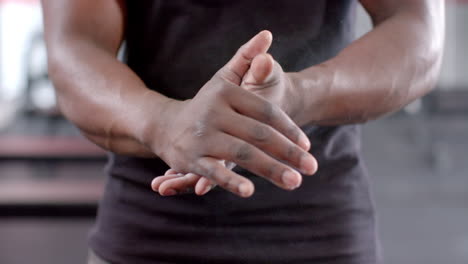 Fit-African-American-man-stretches-his-hands-before-a-workout