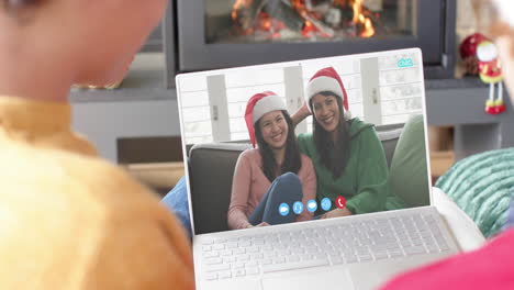 Caucasian-male-friends,-mother-and-daughter-having-christmas-laptop-video-call,-slow-motion