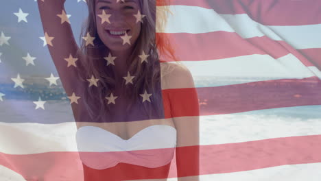 Animation-of-flag-of-usa-over-caucasian-woman-on-beach-in-summer