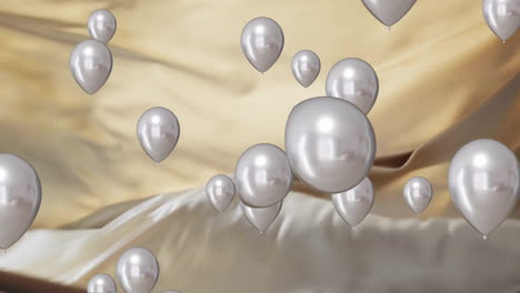 Animation-of-silver-balloons-floating-over-gold-and-black-background