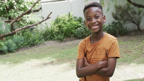 African-American-boy-smiles-confidently-outdoors,-with-copy-space