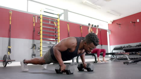 Fit-African-American-man-doing-push-ups-at-the-gym