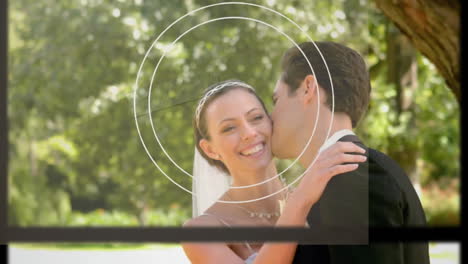 Animation-of-black-lines,-circles-over-caucasian-couple-in-wedding-attire-kissing-during-photoshoot
