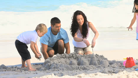 Parents-building-a-sand-castle-with-their-children