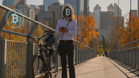 Animation-of-bitcoin-symbols-over-caucasian-businessman-using-smartphone-on-bridge