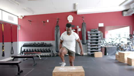 Fit-African-American-man-performs-a-step-up-exercise-at-the-gym
