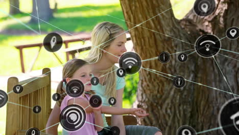Animation-of-network-of-connected-icons-in-circles-over-happy-caucasian-mother-and-daughter