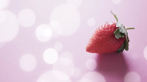 Composition-of-strawberry-and-white-spots-on-pink-background