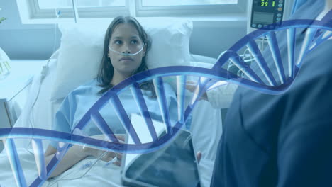 Animation-of-dna-strand-over-diverse-female-doctor-with-tablet-and-patient-in-hospital