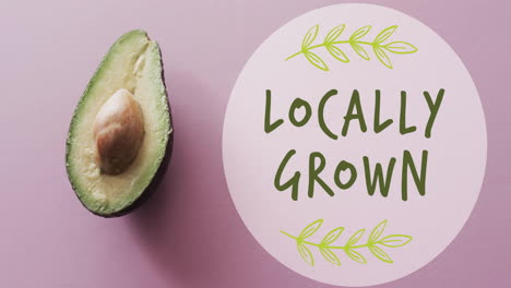 Animation-of-locally-grown-text-on-circle-over-avocado-on-pink-background