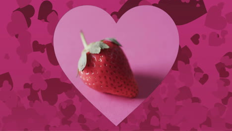 Composition-of-heart-and-strawberry-on-pink-background