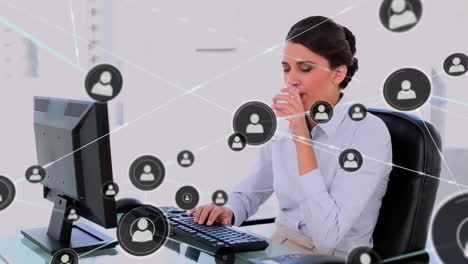 Animation-of-network-of-connections-with-icons-over-caucasian-businesswoman-using-computer