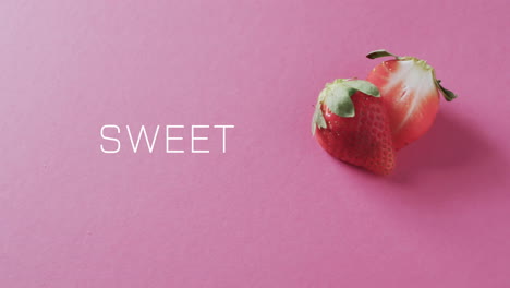 Animation-of-sweet-text-over-halved-strawberry-on-pink-background