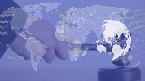 Animation-of-world-map-and-globe-over-hand-using-gavel