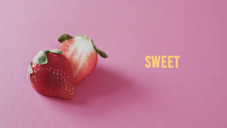 Animation-of-sweet-text-over-halved-strawberries-on-pink-background
