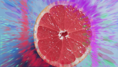 Composition-of-halved-grapefruit-and-spots-of-light-over-red-background