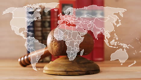 Animation-of-world-map-over-wooden-gavel