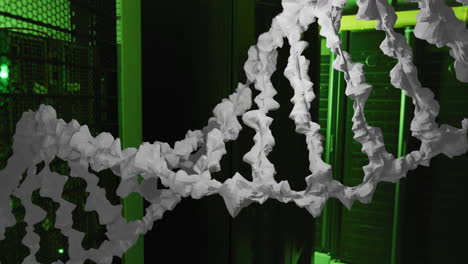 Animation-of-white,-textured-dna-strand-moving-over-dark-computer-server-room