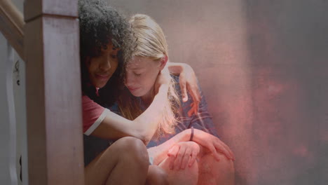 Animation-of-lightning-storm-over-sad-diverse-teenage-girls-comforting-each-other-on-stairs