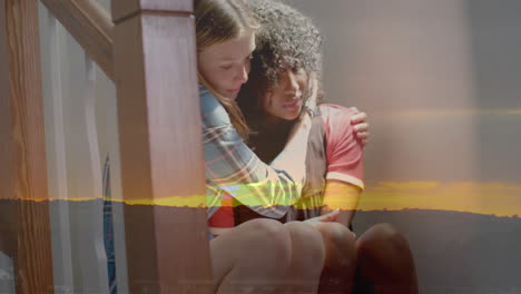 Animation-of-sunset-landscape-over-sad-diverse-teenage-girls-comforting-each-other-on-stairs