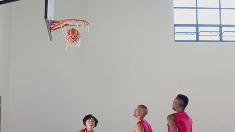 Young-African-American-men-playing-basketball-indoors