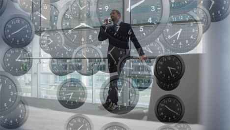 Animation-of-falling-clocks-with-fast-hands-over-caucasian-businessman-talking-on-smartphone