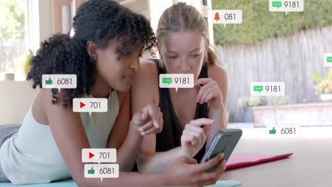 Animation-of-social-media-text-and-icons-over-diverse-girlfriends-using-smartphone