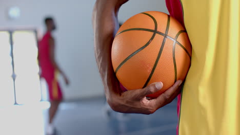 Close-up-of-a-basketball-held-by-an-African-American-man