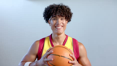 Young-biracial-man-holding-a-basketball
