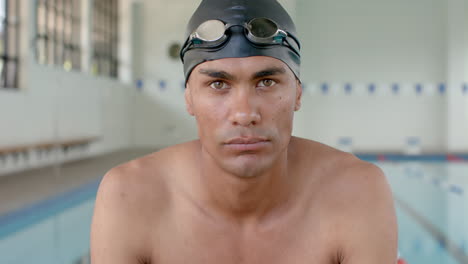 Young-biracial-male-athlete-swimmer-ready-for-a-swim-at-the-pool