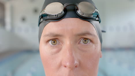 Caucasian-female-swimmer-athlete-wearing-swimming-goggles