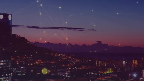 Animation-of-network-of-connections-with-glowing-spots-over-cityscape