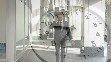 Animation-of-clock-with-fast-moving-hands-over-caucasian-businessman-walking,-talking-on-smartphone