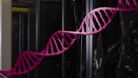 Animation-of-pink-dna-strand-moving-over-dark-computer-servers