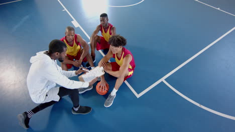 African-American-and-biracial-men-strategize-on-the-basketball-court