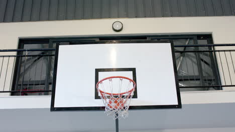 A-basketball-hoop-is-mounted-on-an-outdoor-wall,-with-copy-space