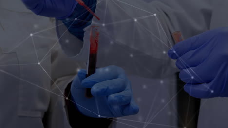 Animation-of-network-of-connections-over-diverse-doctors-holding-test-tubes