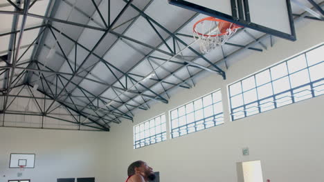 African-American-man-playing-basketball-indoors,-with-copy-space