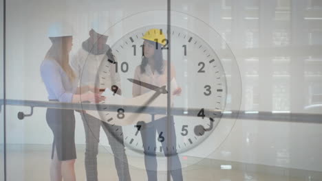 Animation-of-clock-with-fast-moving-hands-over-diverse-architects-studying-blueprints